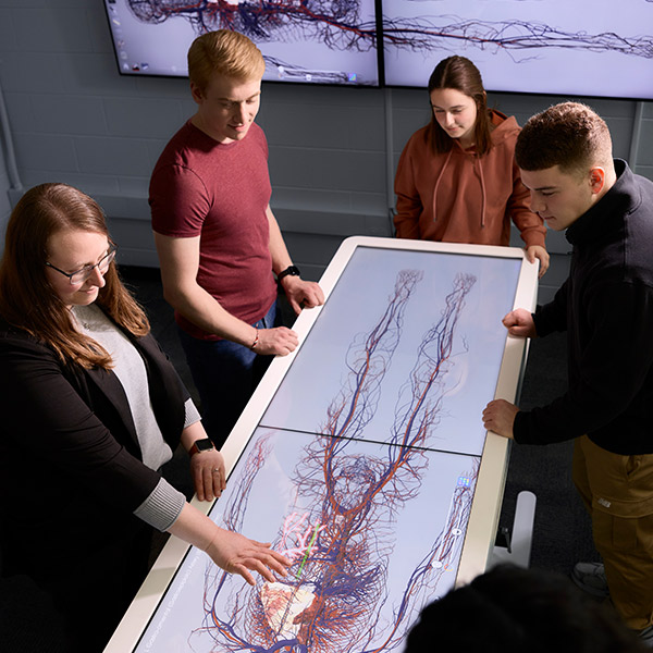 Students gather around an anamatage machine, used for Medical research