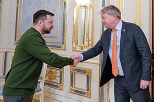 Needham shakes hands with President Zelensky