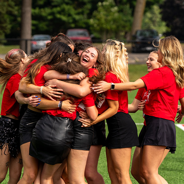 A group of sorority sisters hug after a member is chosen