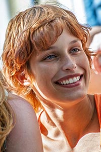 McKay with red hair smiles big