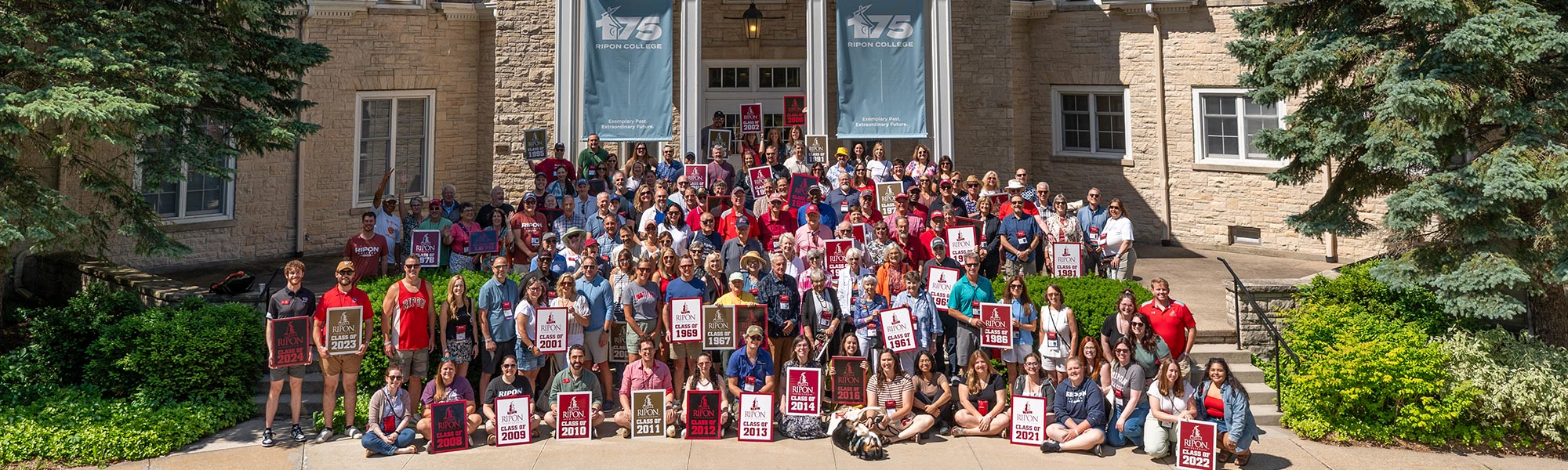 A group of excited Alumni outside of Great Hall