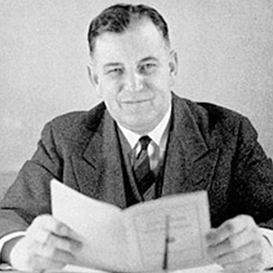 Davies with a small pamphlet in front of him.