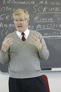 Smith speaking in front of chalkboard