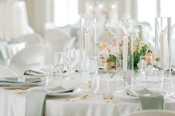 Tables are set with candles, fancy glasses and more