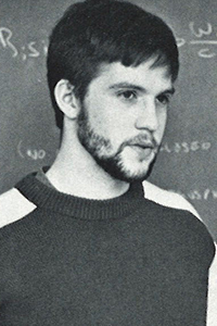 Huebner in front of chalkboard