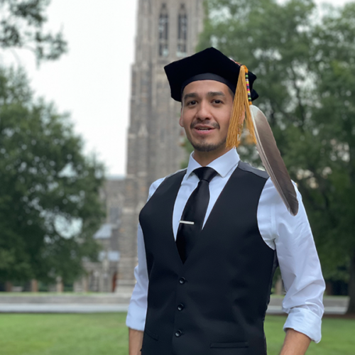 Raymond standing in front of Cathedral with feathers
