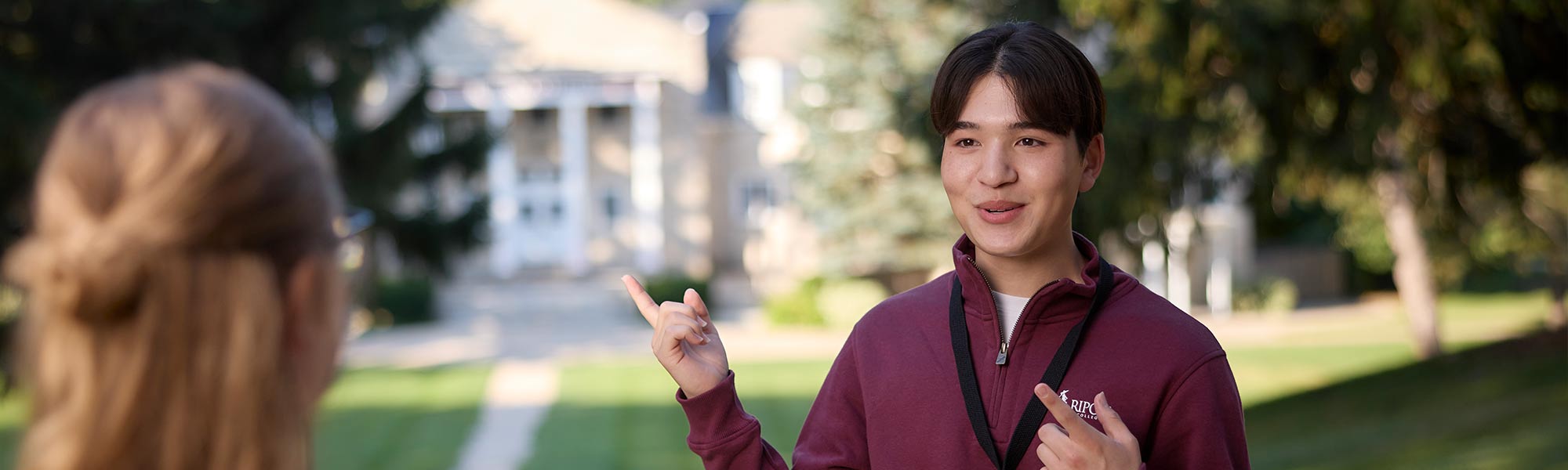 A student ambassador gives directions to Harwood Hall