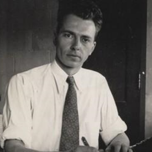 Soule working at a desk in a tie