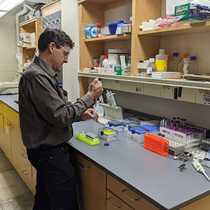 Frey stands at a desk with medical devices