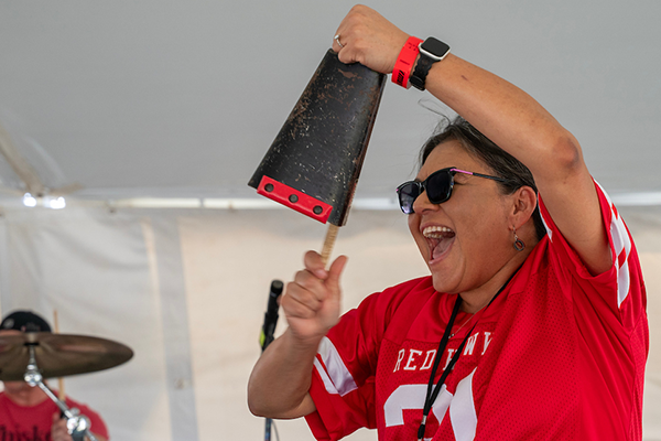 Red Hawk hits the cowbell during homecoming celebration