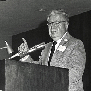 Reisz stands at a podium in Ripon College