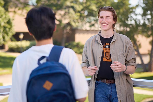 Students laugh while standing on the stargazer deck in the Franzen Science Center