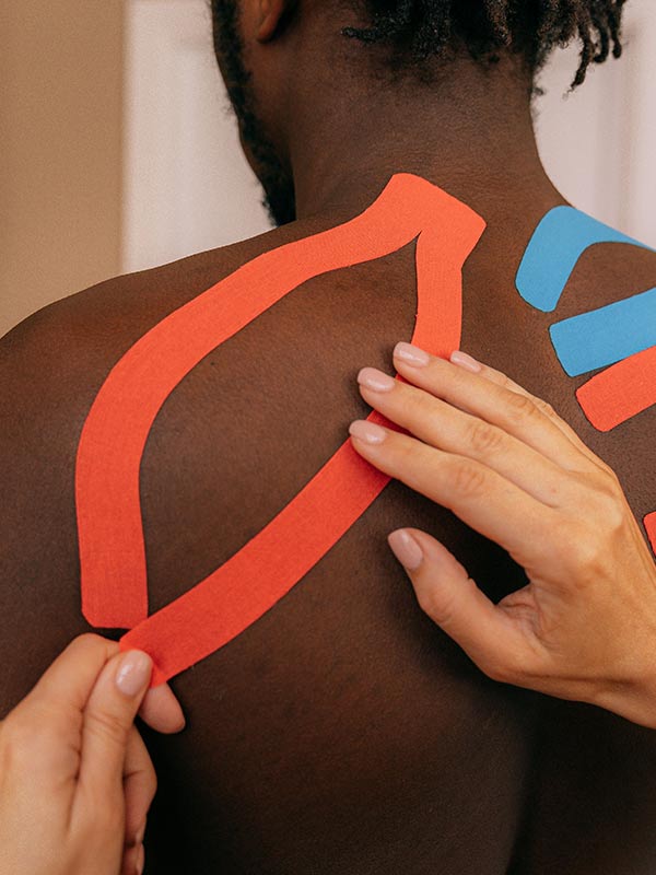 Taped up Chiropractic patient-photo by Antoni Shkraba