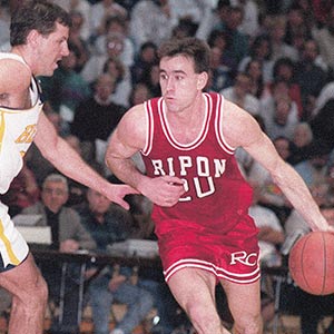 Brad dribbles down the court as a Red Hawk