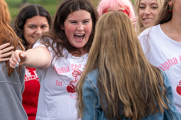 Photo of female students excitedly embracing