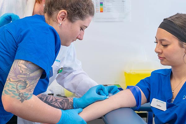 A nurse finds the vein of a patient photo by Sahil-Singh-from-pexels