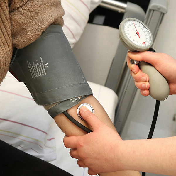A nurse takes blood pressure measurements