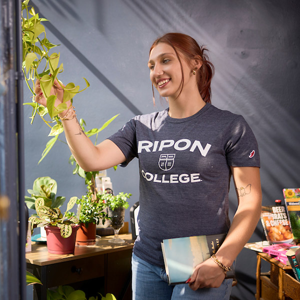 A student looks at a Pathos plant in a Ripon Dough Co