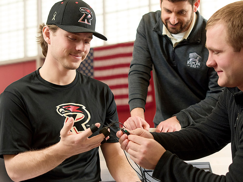 A pitcher has wires connected to fingers to test throwing strength