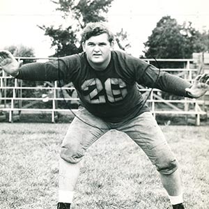 Tiny takes a strong stance in Football uniform.